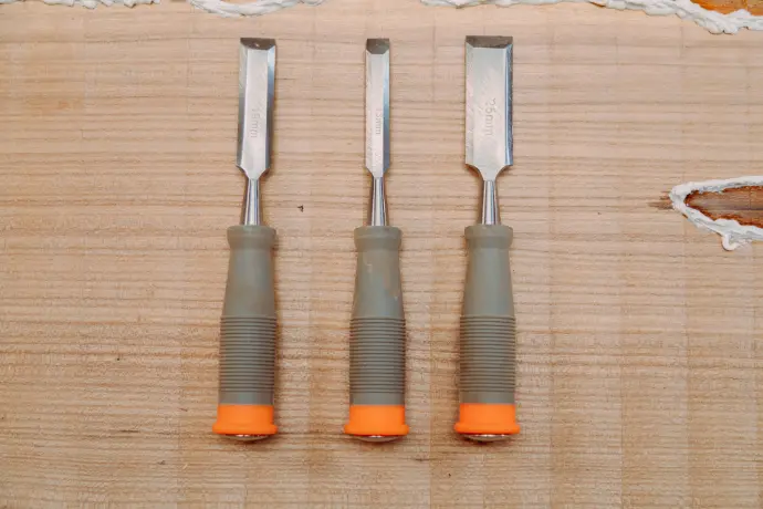 a couple of tools that are on a table named as chisel